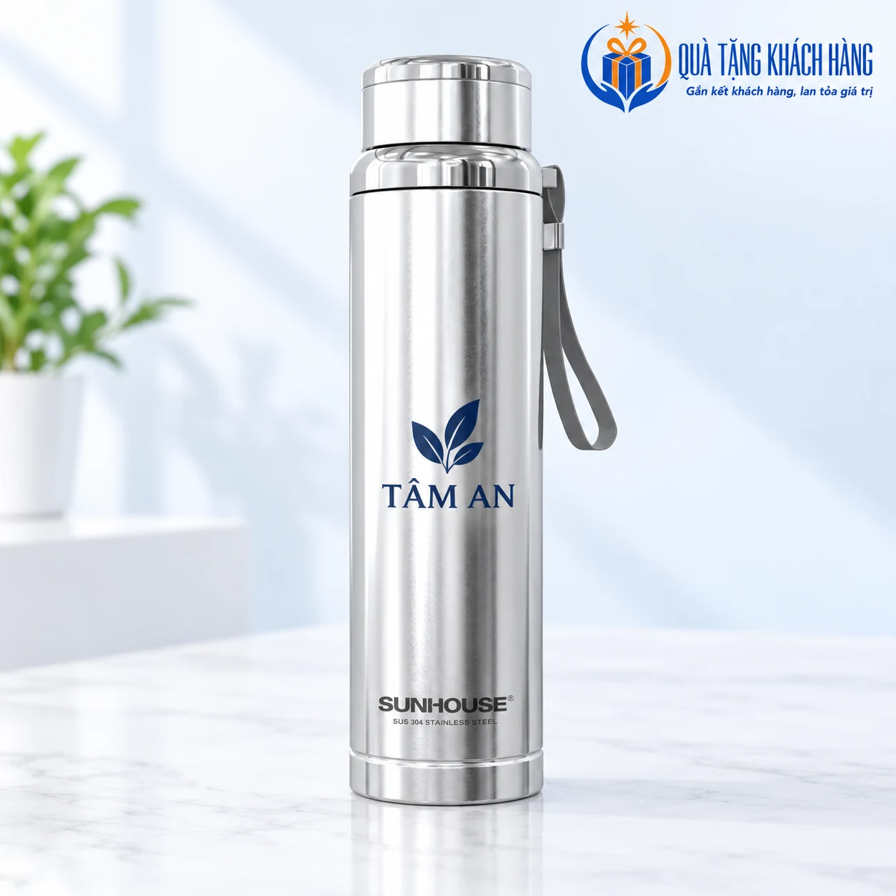 Bình Sunhouse Flexi inox có biểu tượng lá và tên TÂM AN xanh ở giữa thân.