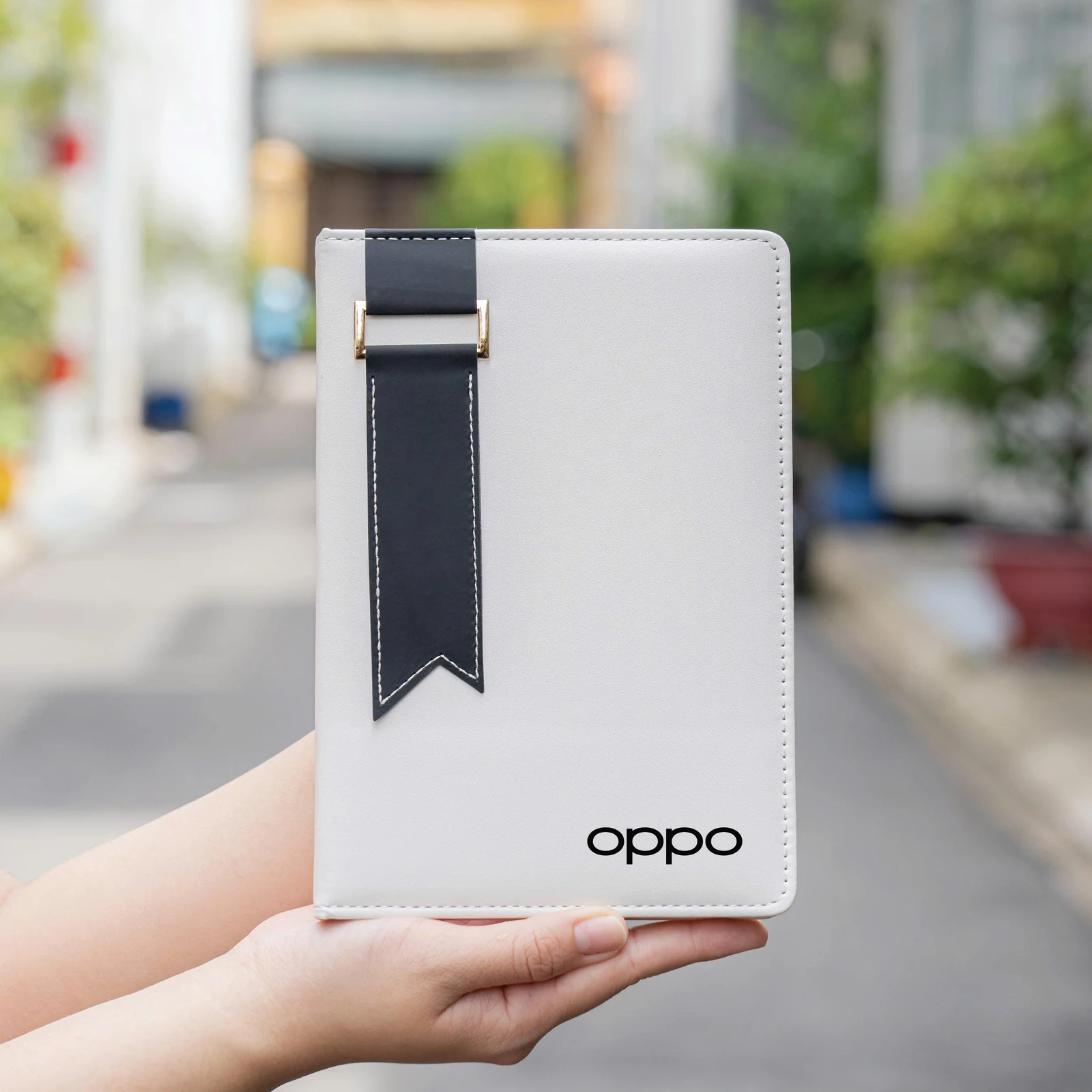 Sổ trắng dải đen có nhận diện OPPO đen trên bìa trong ảnh nguồn.