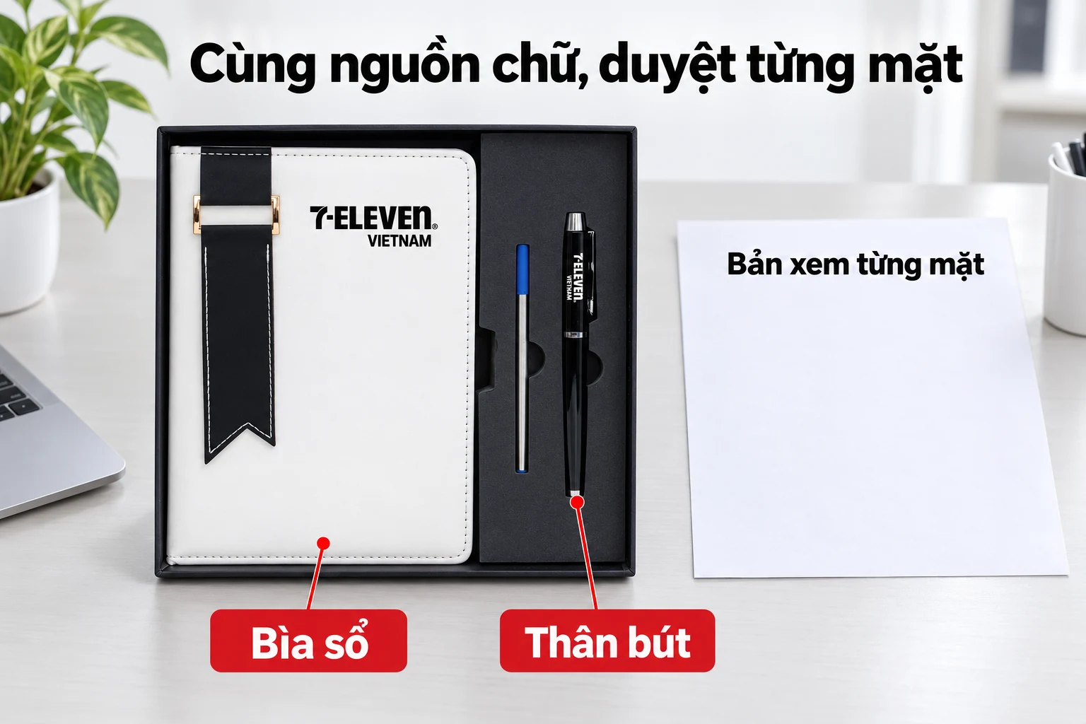 Sổ và bút nguồn màu đen trắng cạnh tờ bản xem minh họa, nhãn chỉ bìa sổ và thân bút.